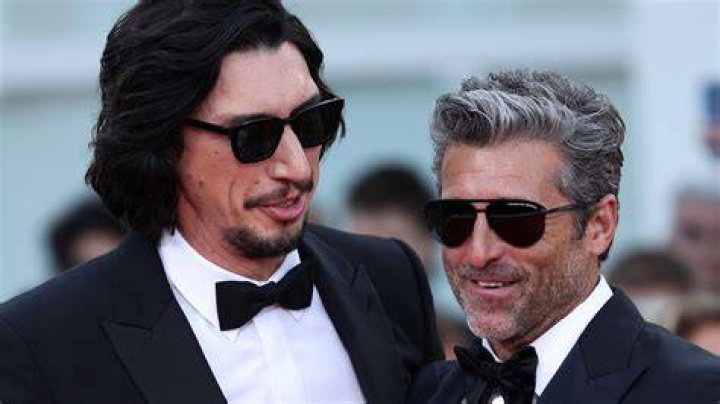 Adam Driver and Patrick Dempsey are standing together on a red carpet.