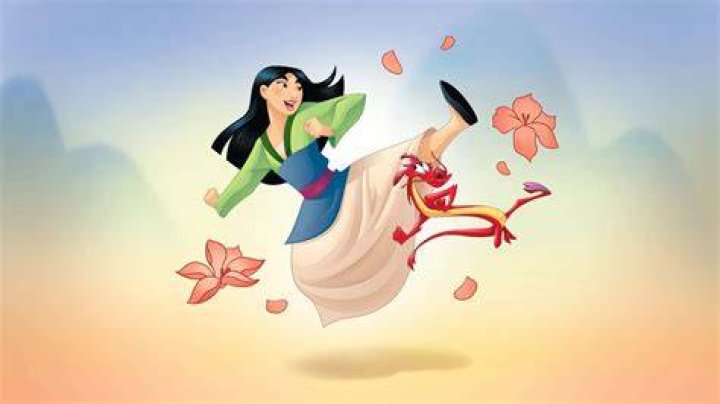 Mulan's reflection shows in her sword as she prepares to cut her hair
